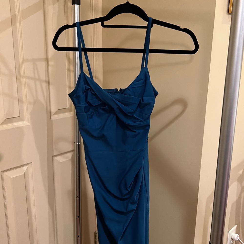 Hourglass, classic, form fitting. turquoise dress, spaghetti strap.